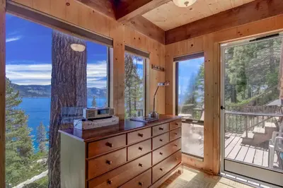 a bedroom with a dresser and a large window at Stunning Views at Stargazer - Lakefront Studio in Crystal Bay