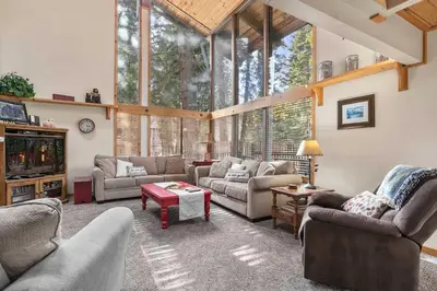 a living room with couches and a large window at Sundance - Foosball Table BBQ Near West Beach in Carnelian Bay
