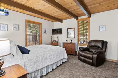 a bedroom with a bed and a chair at Sundance - Foosball Table BBQ Near West Beach in Carnelian Bay