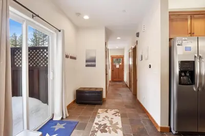 a hallway of a house with a refrigerator at Sunny Woods Acres - Near Golf & Adventure Park in Tahoe Vista