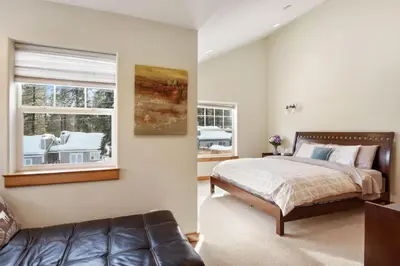 a bedroom with a bed and a couch and a window at Sunny Woods Acres - Near Golf & Adventure Park in Tahoe Vista