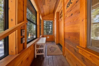 a hallway of a wooden cabin with windows at Tahoe City Retreat - For 8 in Tahoe City