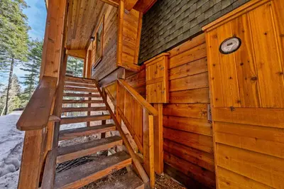 a wooden cabin with stairs leading to the backdoor at Tahoe City Retreat - For 8 in Tahoe City