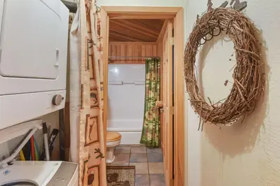 a bathroom with a mirror and a toilet at Tahoe Pines Cabin in Homewood