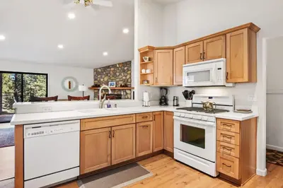 a kitchen with white appliances and wooden cabinets at Tranquil Tumbleweed - Close to Skiing & More in Incline Village