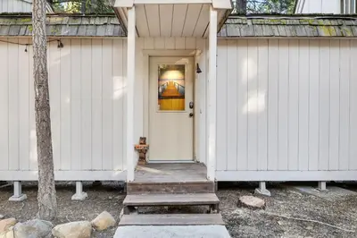 a white house with a white door and a porch at Truckee Cabin Getaway - Sleeps 6 in Truckee