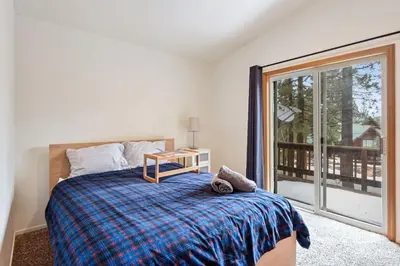 a bedroom with a bed and a large window at Truckee Pines Retreat - Game Room & Forest Views in Truckee