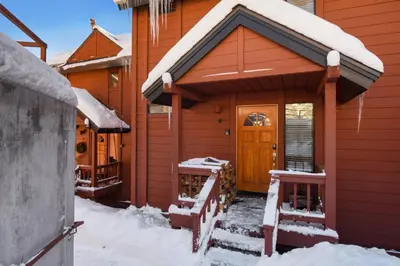 a house with snow on the porch of it at Valley View Bliss - Nearby Bike Trails & Beach in Olympic Valley