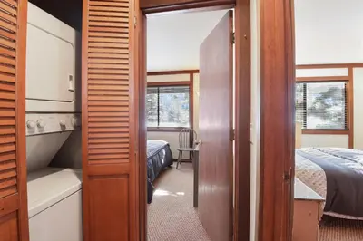a small room with a bed and a door to a bedroom at Valley View Bliss - Nearby Bike Trails & Beach in Olympic Valley