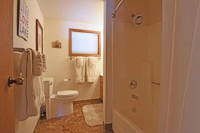 a bathroom with a toilet and a shower with towels at Vista Point - 5 Minutes to Kings Beach in Tahoe Vista