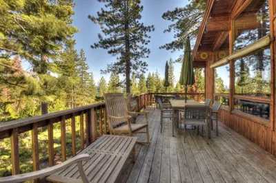 a deck with chairs and tables on a cabin at Vista Point - 5 Minutes to Kings Beach in Tahoe Vista