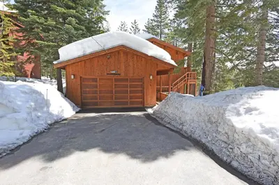 a wooden building with a snow covered garage at Vista Point - 5 Minutes to Kings Beach in Tahoe Vista