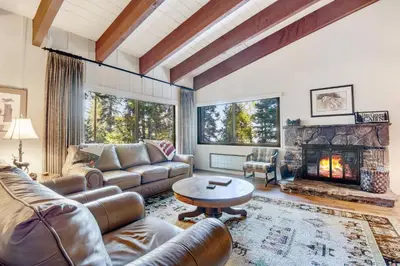 a living room with a couch and a fireplace at Waters Edge Escape - Patio with BBQ Near Beach in Tahoma