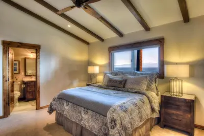 a bedroom with a large bed and a window at Waters Edge Jewel with Lake Views - HOA Access in Tahoma