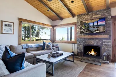 a living room with a couch and a fireplace at Waters Edge Jewel with Lake Views - HOA Access in Tahoma
