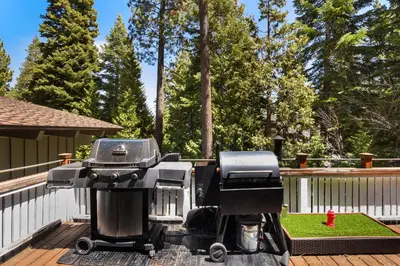 a grill sitting on top of a deck at Waters Edge Oasis - Shared Pool & Pier Access in Tahoma
