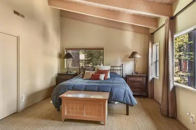 a bedroom with a bed and a window at Waters Edge Oasis - Shared Pool & Pier Access in Tahoma