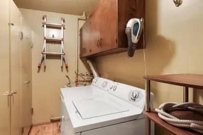 a kitchen with a sink and a phone on the wall at Waters Edge Oasis - Shared Pool & Pier Access in Tahoma