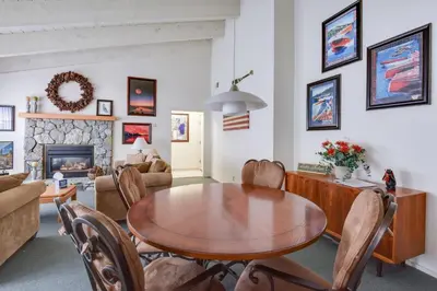 a living room with a wooden table and chairs at Waters Edge Vista - HOA Pool & Pier Access in Tahoma