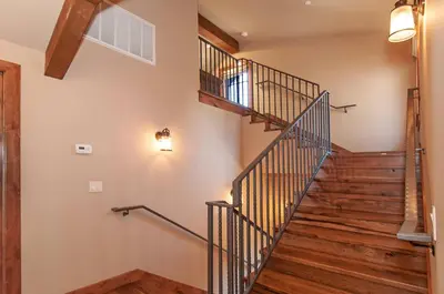 a staircase in a house with wooden floors at West Lake Serenity with 180-Degree Lake Views in Homewood