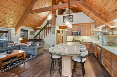 a kitchen and living room with a table and chairs at West Shore Haven - Near Beach & Outdoor Fun in Tahoma