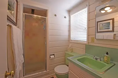 a bathroom with a green sink and a shower at Woodland Chalet - 2 miles from Beach Access in Tahoma