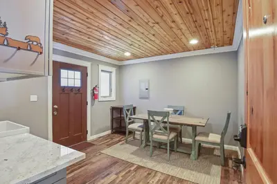a kitchen and dining room with a wooden ceiling at Alpine Chalet Nature Lovers Rejoice Chic 4 BDR in Alpine Meadows