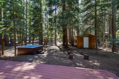 a tent and a tub in a forest with trees at Alpine Gem Near Homewood Mountain in Tahoma