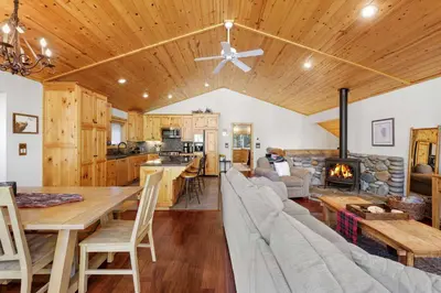 a kitchen and living room with a couch and a fireplace at Alpine Gem Near Homewood Mountain in Tahoma