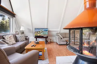 a living room with couches and a fishtank at Woodside Hideout - Hop Away from Activities in Tahoma