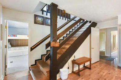 a staircase in a home with a wooden floor at Woodside Hideout - Hop Away from Activities in Tahoma