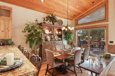 an open kitchen and dining room with a table and chairs at Wulf's Lodge at Olympic Valley - Unwind in Hot Tub in Olympic Valley