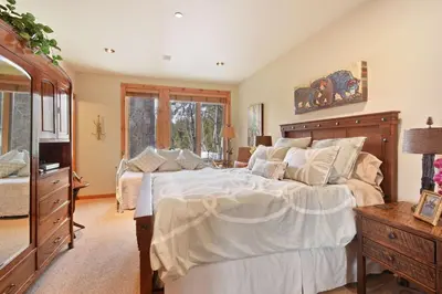 a bedroom with a large bed and a dresser at Wulf's Lodge at Olympic Valley - Unwind in Hot Tub in Olympic Valley