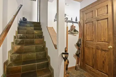 a stairway with a wooden door and a stair case at Alpine Manor Retreat Mountain Relaxation in Alpine Meadows