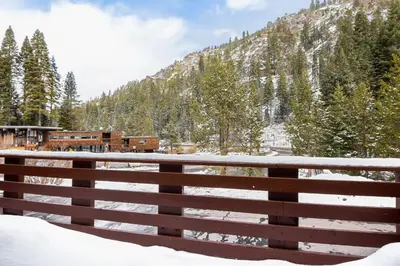 a fence in the snow with a mountain in the background at Alpine Manor Retreat Mountain Relaxation in Alpine Meadows