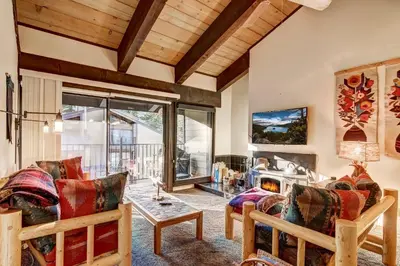 a living room with a couch and a table at Alpine Meadows Peak 15 Min to Commons Beach in Alpine Meadows