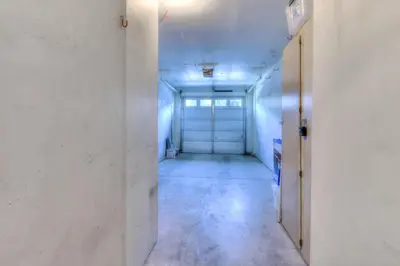 an empty hallway with white walls and a door at Alpine Way Lake & Sugar Bowl Resort in Truckee