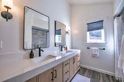 a bathroom with two sinks and a large mirror at Bearfoot Lodge Near Fishing and Hiking in Truckee