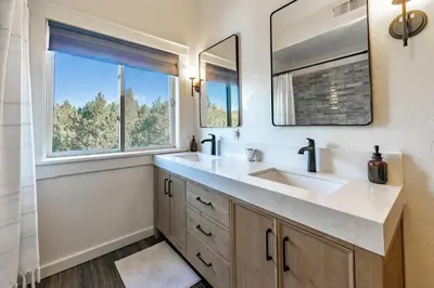 a bathroom with a sink and two windows at Bearfoot Lodge Near Fishing and Hiking in Truckee