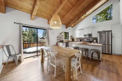 a large kitchen with a wooden table and chairs at Bright & Modern Cabin Luxury Home in Carnelian Bay in Carnelian Bay
