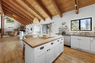 a kitchen with white cabinets and a wooden ceiling at Bright & Modern Cabin Luxury Home in Carnelian Bay in Carnelian Bay