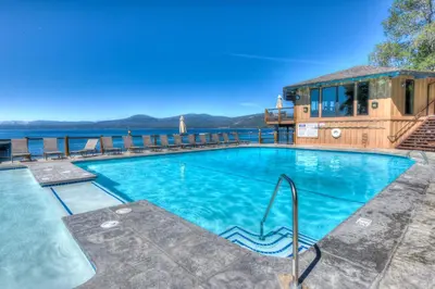 a swimming pool with a view of the water at Brockway Springs Lodge Steps to Lake Access in Kings Beach