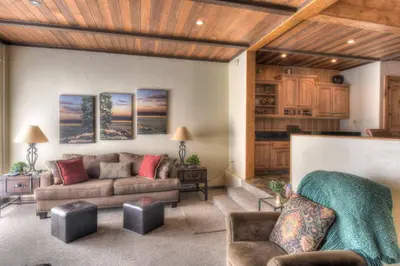 a living room with a couch and a table at Brockway Springs Lodge Steps to Lake Access in Kings Beach