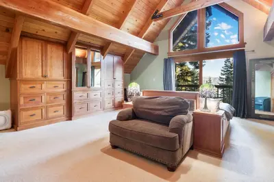 a living room with a chair and a large window at Carnelian Bay Getaway in Carnelian Bay