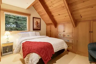 a bedroom with a bed with a red and white blanket at Carnelian Bay Getaway in Carnelian Bay
