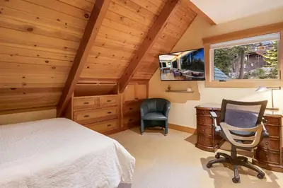 a bedroom with a bed and a desk and a chair at Carnelian Bay Getaway in Carnelian Bay