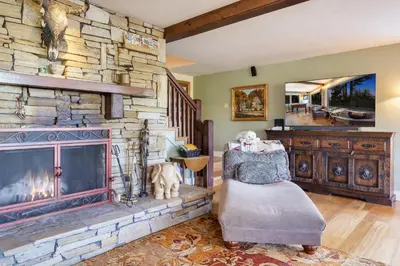 a living room with a large stone fireplace at Carnelian Bay Getaway in Carnelian Bay