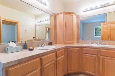 a bathroom with two sinks and a large mirror at Cedar Chateau with Game Room & HOA Access in Truckee