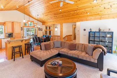 a living room with a couch and a table at Cedar Chateau with Game Room & HOA Access in Truckee