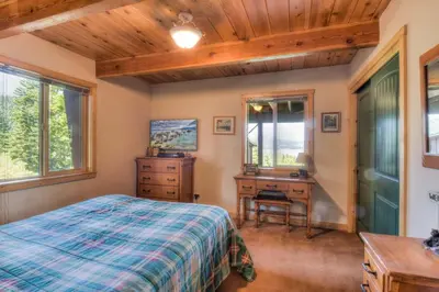 a bedroom with a bed and a desk and window at Chamberland Getaway Lake Views with Deck in Tahoma